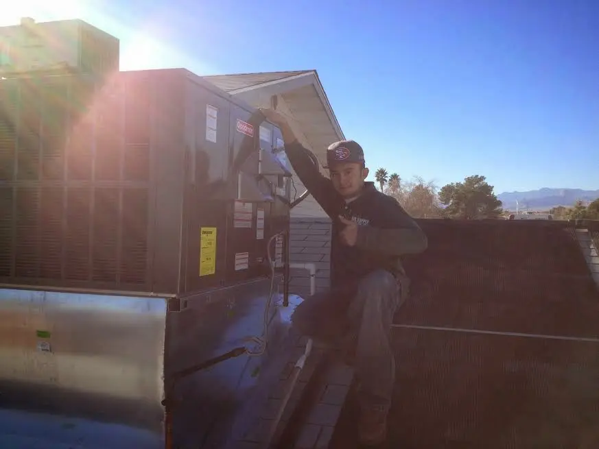 HVAC technician performing Boiler Repair on a rooftop unit in Pantops